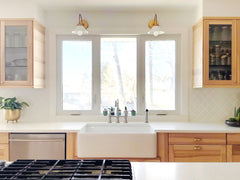Traditional white and wood kitchen with brass sconces with white shades