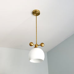 white and brass modern globe pendant with brass orb ball details midcentury inspired