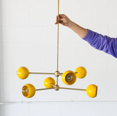 Yellow and Brass mid century modern chandelier with globe shades