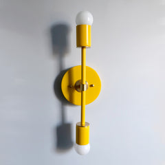 Yellow and brass two light modern wall sconce