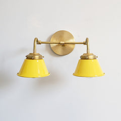 Sunshine Yellow and Brass Double Kelly Sconce features colorful shades and a raw brass finish modern bathroom lighting