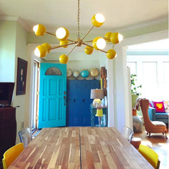 Yellow & Brass Orion Chandelier in a dining room