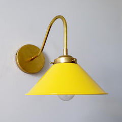 Yellow and brass modern farmhouse wall sconce with a colorful shade.  Perfect for open shelving in kitchens and small bathroom design