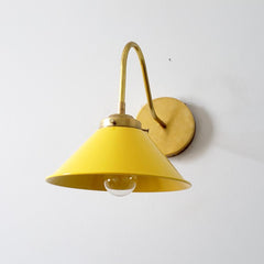 Yellow and brass modern farmhouse wall sconce with a colorful shade.  Perfect for open shelving in kitchens and small bathroom design