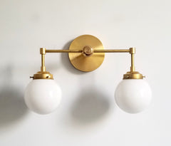brass and white two light wall sconces