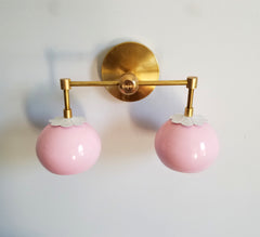 pink and white and brass two light sconce mid century feminine color