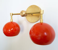 brass and orange wall sconce with two lights enamel shades