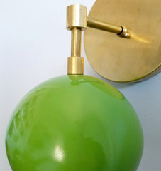 closeup image of green and brass wall sconce