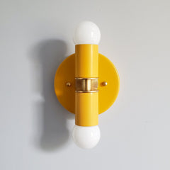 Mustard and Brass two light wall sconce or flush mount ceiling light fixture in a bright vibrant color and mid century modern or art deco design