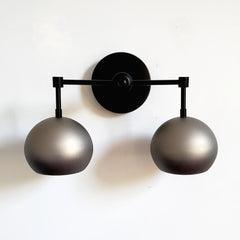 matte black and steel two light wall sconce for bathrooms, kitchens, bedrooms etc. Industrial style finishes with a mid century modern design