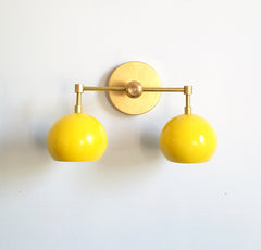 Double Loa sconce in brass and yellow midcentury modern style