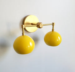 brass and yellow modern two-light fixture with globe shaped shades