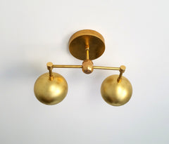 Double Loa Sconce in Raw Brass